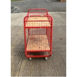 red_picking_trolley_small_and_rigid_with_3_mesh_sides_and_2_swivel_and_2_fixed_castors_also_a_4th_side_above_the_maincompartment_to_allow_the_top_shelf_to_be_3