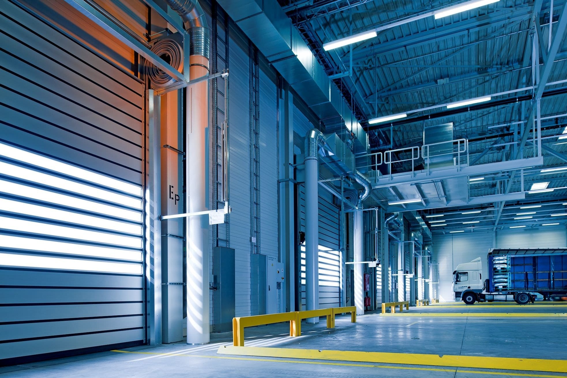 a warehouse swapping out wooden pallets for steel stillages