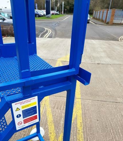 Wing gate folded up on side of lorry access step